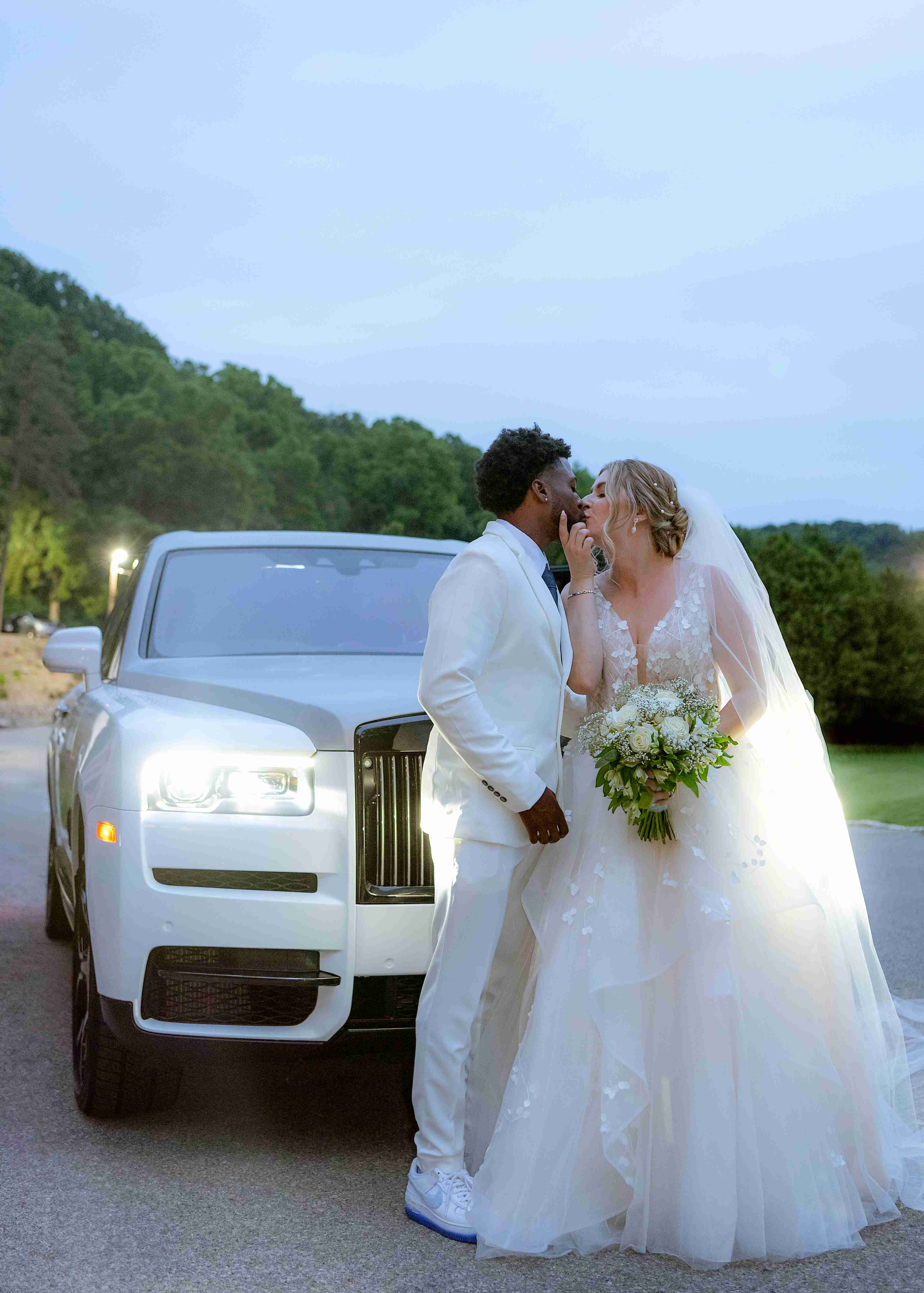 Couple in romantic dusk portrait beside a luxury car in Hamilton, Ontario — editorial wedding photography