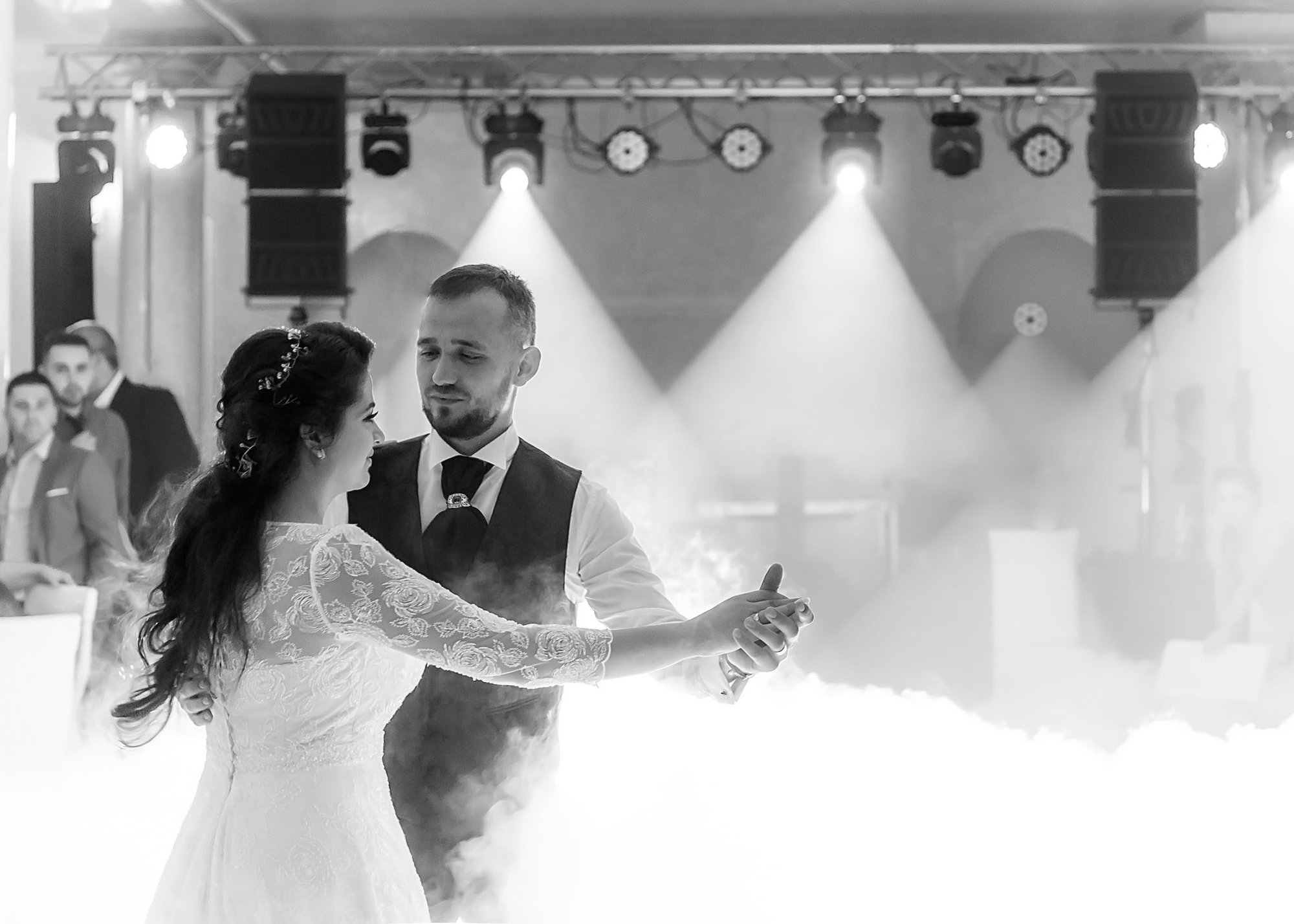 Black-and-white documentary wedding reception photograph in Romania — bride and groom sharing their first dance, fine art destination photography by NN Popa