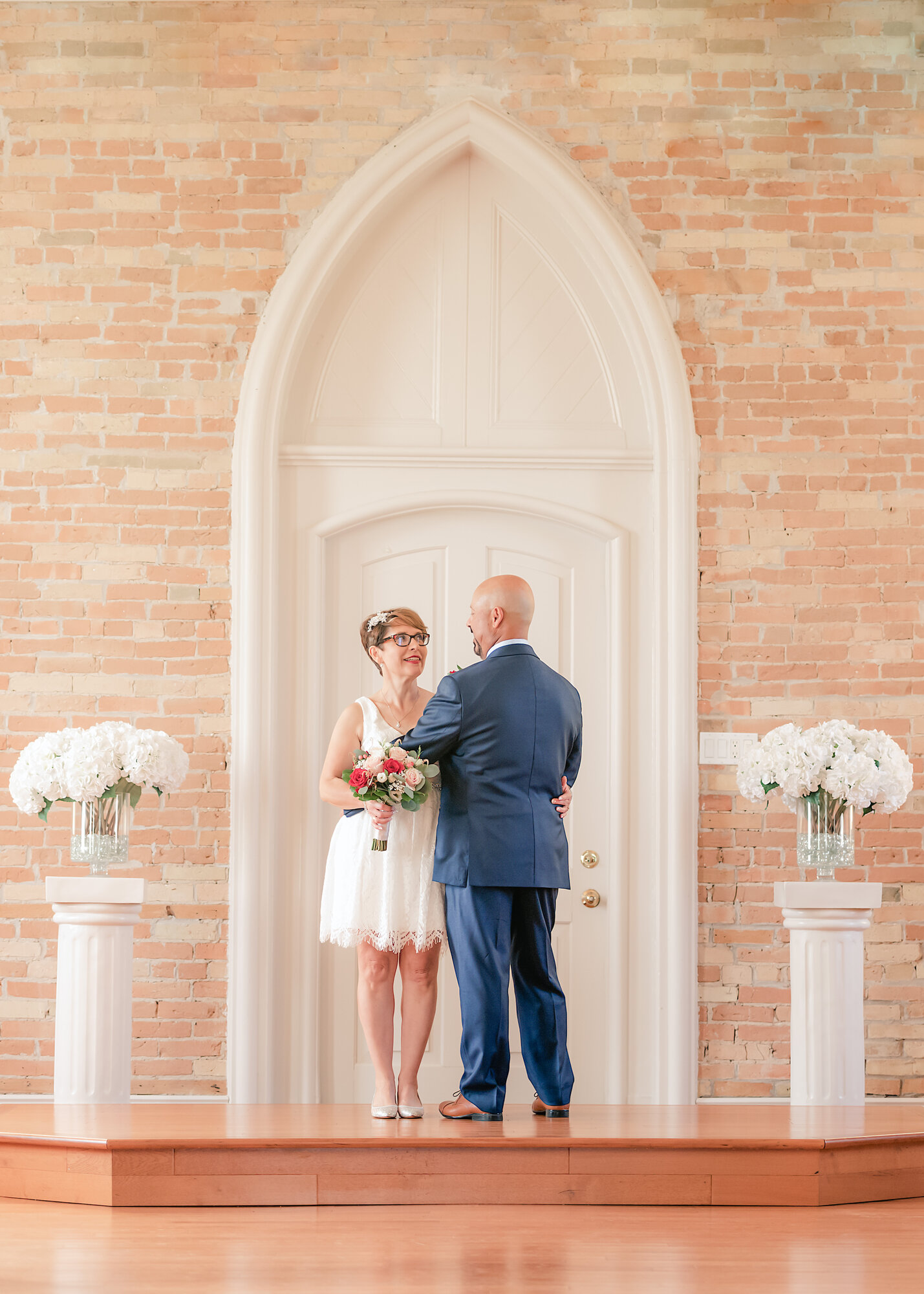 Bride and groom sharing a quiet moment in a chapel ceremony — documentary wedding photography by NN Popa Photography
