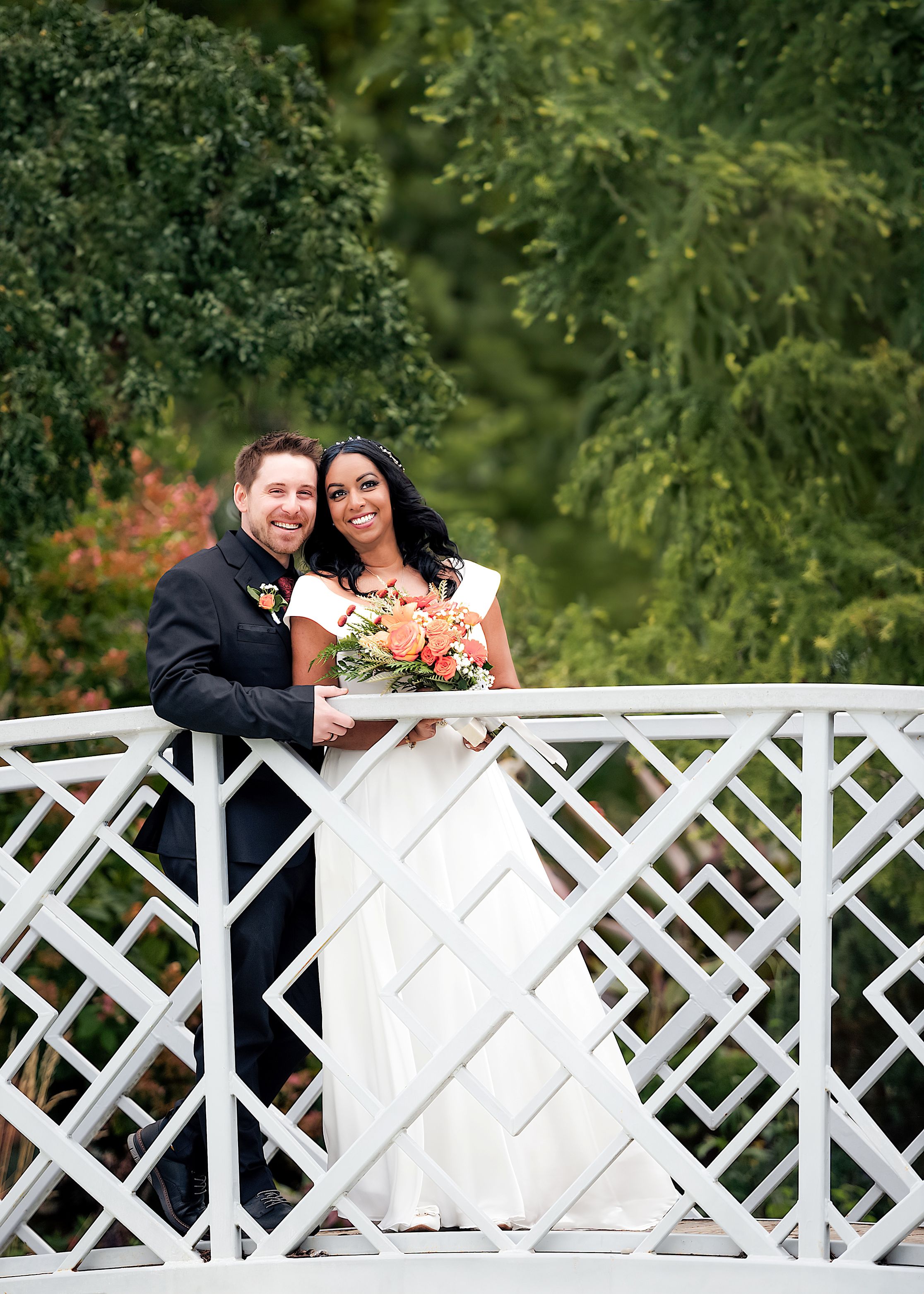 Couple sharing a romantic moment on an outdoor bridge in Kitchener, Ontario — fine art wedding photography